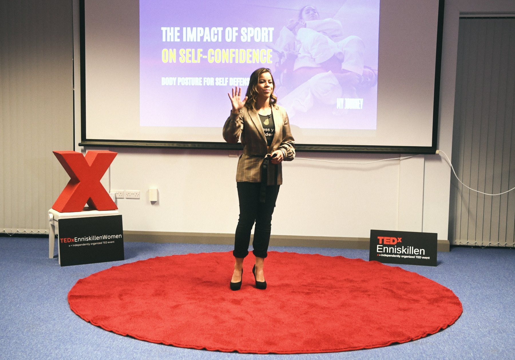 Jaqueline speaking at TEDx, her slide reading The Impact of Sport on Self-Confidence